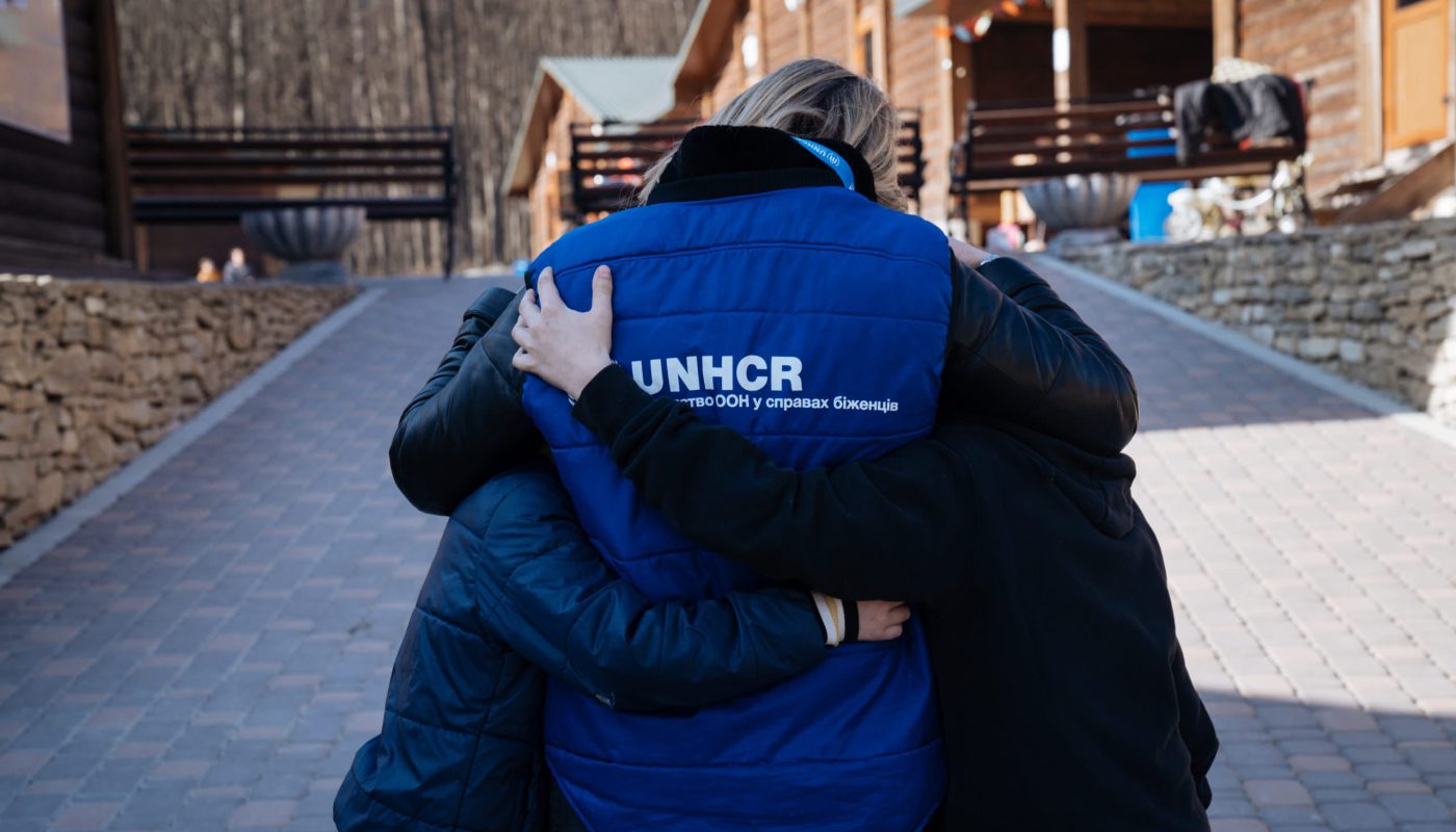 UNHCR staff member comforts two displaced boys who found refuge at the “Your Camp” reception centre for displaced people in a village in the Chernivtsi region in western Ukraine. UNHCR has provided bed linen at the centre which hosts 200 displaced people per day. ; UNHCR has been present in Ukraine since 1994, working closely with the Ukrainian government and civil society in responding to forced displacement. It works closely with local authorities and humanitarian partners. Efforts are focused on protection, shelter, and cash and in-kind assistance. More than 4.5 million refugees have fled to neighbouring countries since the war started on 24 February 2022. Inside the country, more than 7 million people are estimated to have been displaced.